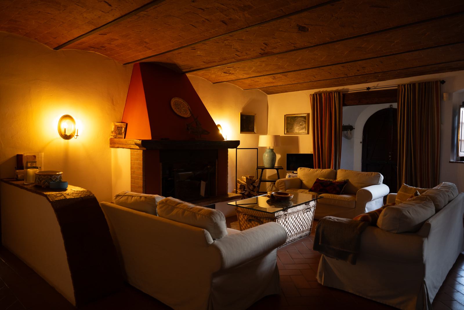 Sala del camino sotto una volta in mattoni, di sera
